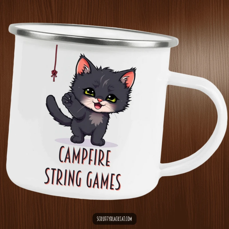 Funny enamel camping mug with a scruffy black kitten gleefully playing with a dangling string, perfect for outdoor fun.