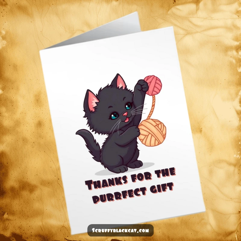 Funny Free Printable Thank You Card: A cute scruffy black kitten batting playfully at a bright red ball of yarn.