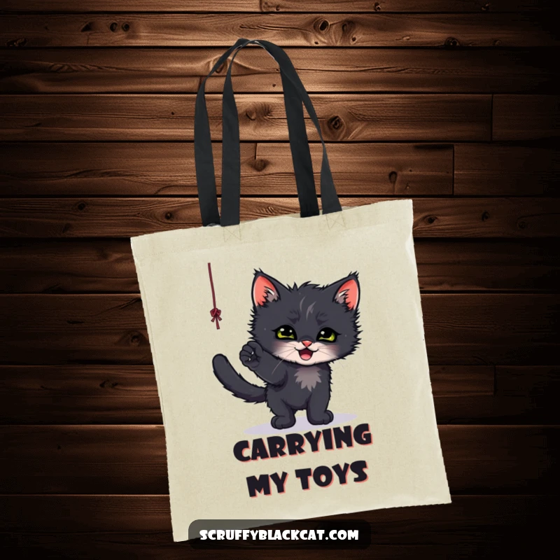 Funny tote bag showcasing a scruffy black kitten playfully batting at a dangling string, perfect for errands.