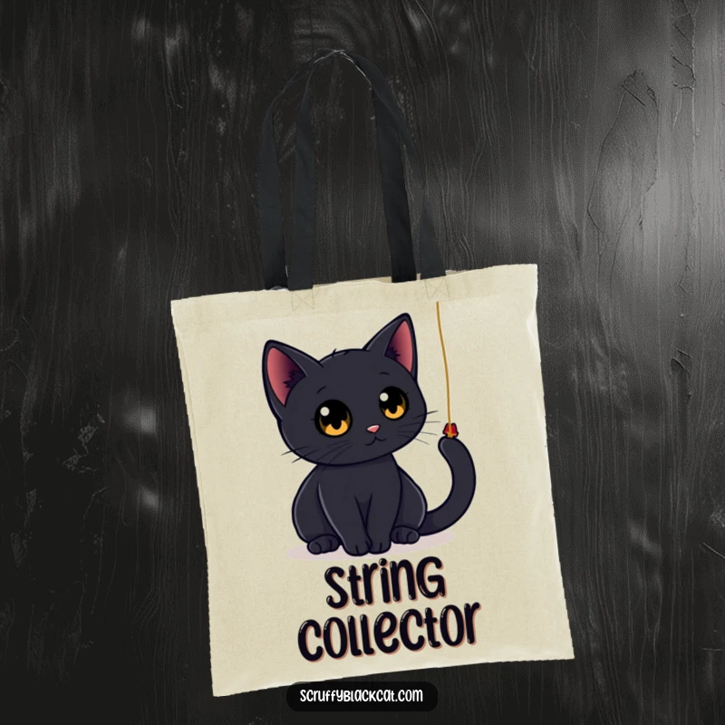 Funny black cat tote bag showing a sleek cat with large, round eyes playfully batting at a dangling string, great for carrying essentials with feline flair.